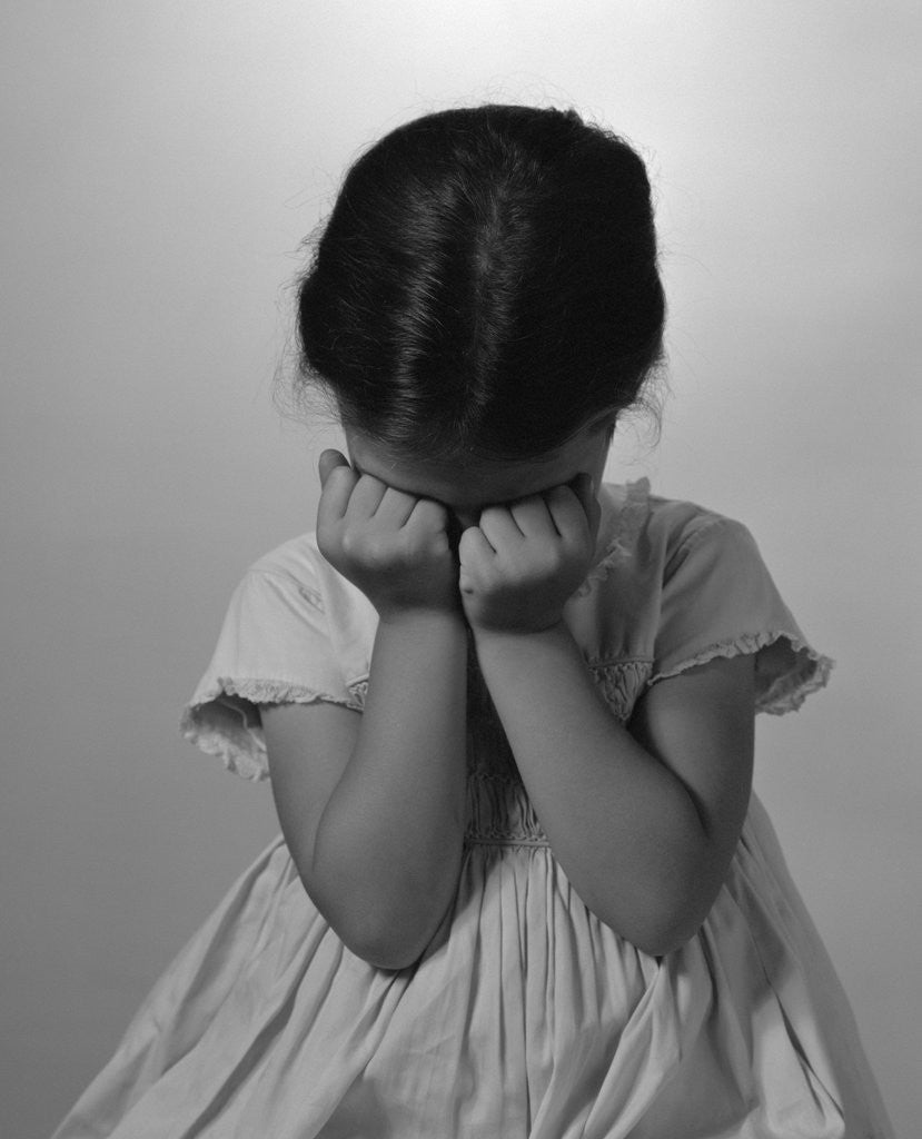 Detail of 1960s Sad Little Girl Sitting Hands On Face Crying by Corbis