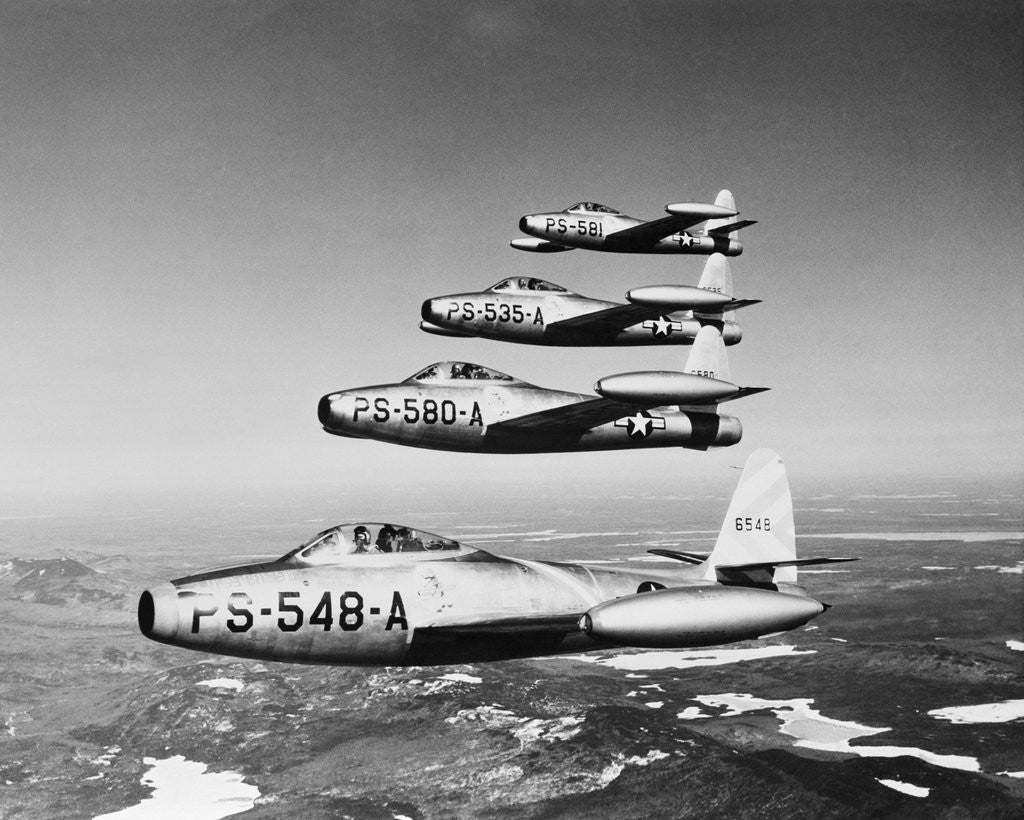 Detail of 1950s four US air force F-84 thunder jet fighter bomber airplanes in flight by Corbis