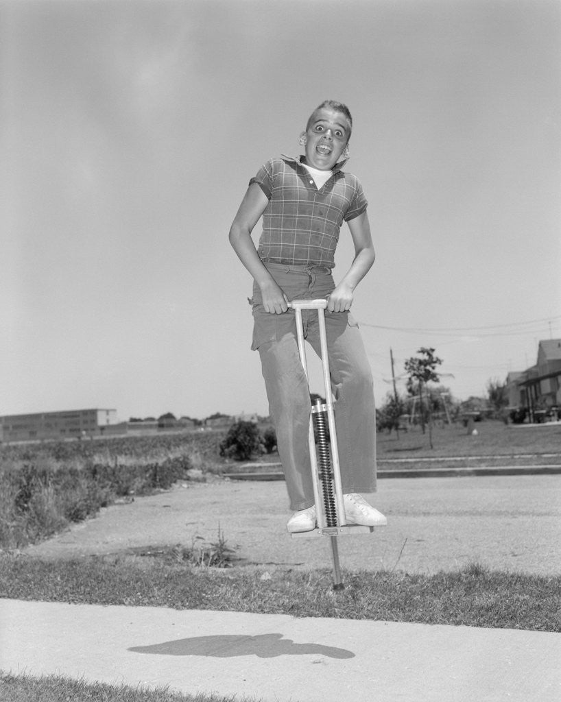 Detail of 1950s boy jumping on pogo stick by Corbis