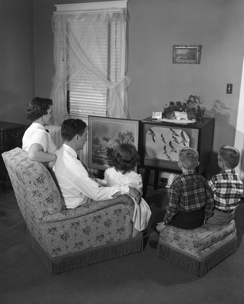 Detail of 1950s family watching television by Corbis