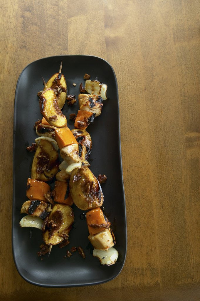 Detail of Chicken, peach, and sweet potato skewers by Corbis