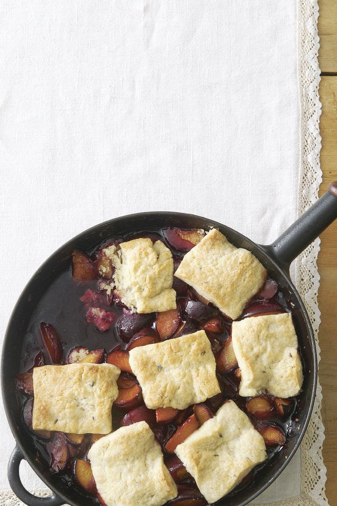 Detail of Plum cobbler with honey lavender biscuits by Corbis