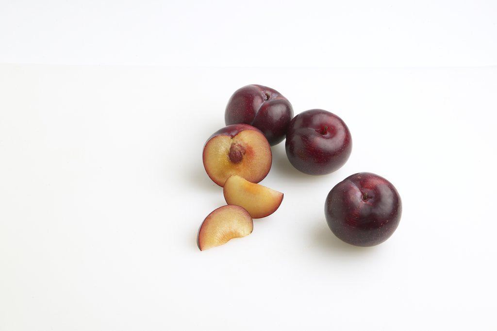 Detail of Sliced plums by Corbis