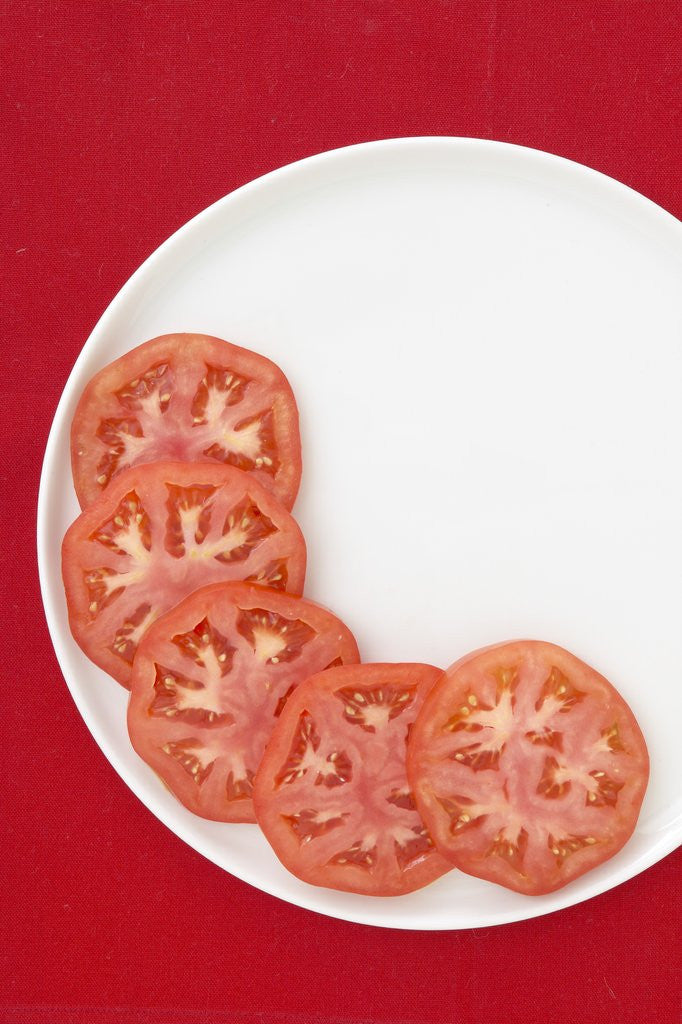 Detail of Tomato slices on a plate by Corbis