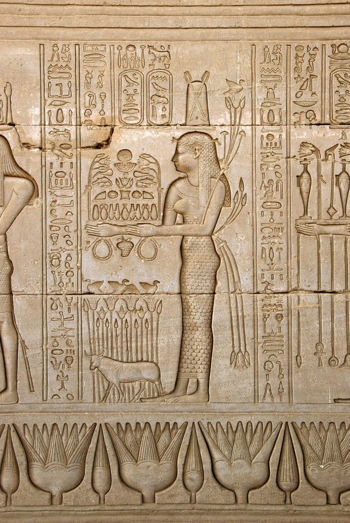 Detail of Ancient Egyptian sunken relief depicting woman bringing offerings to the goddess Hathor by Corbis