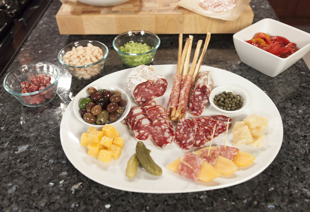 Detail of Salumi tasting plate with paired foods by Corbis