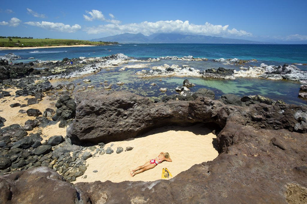 Detail of Woman sunbathing in secluded area of sand, Ho'okipa Beach Park, Maui, Hawaii MR by Corbis