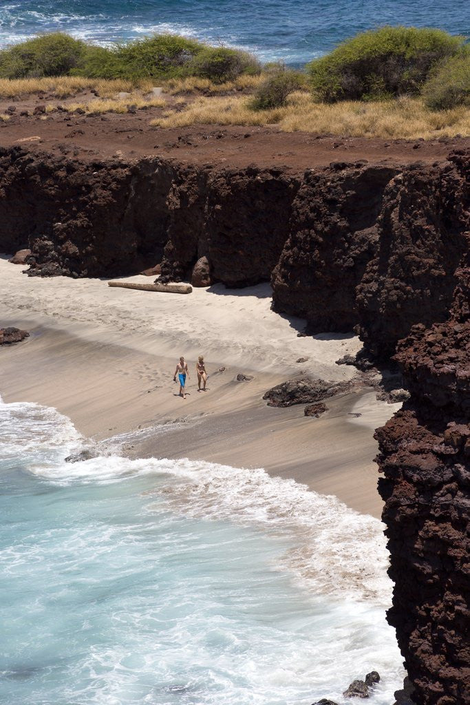 Detail of Couple walking on secluded beach at Shark's cove, Lanai, Hawaii MR by Corbis