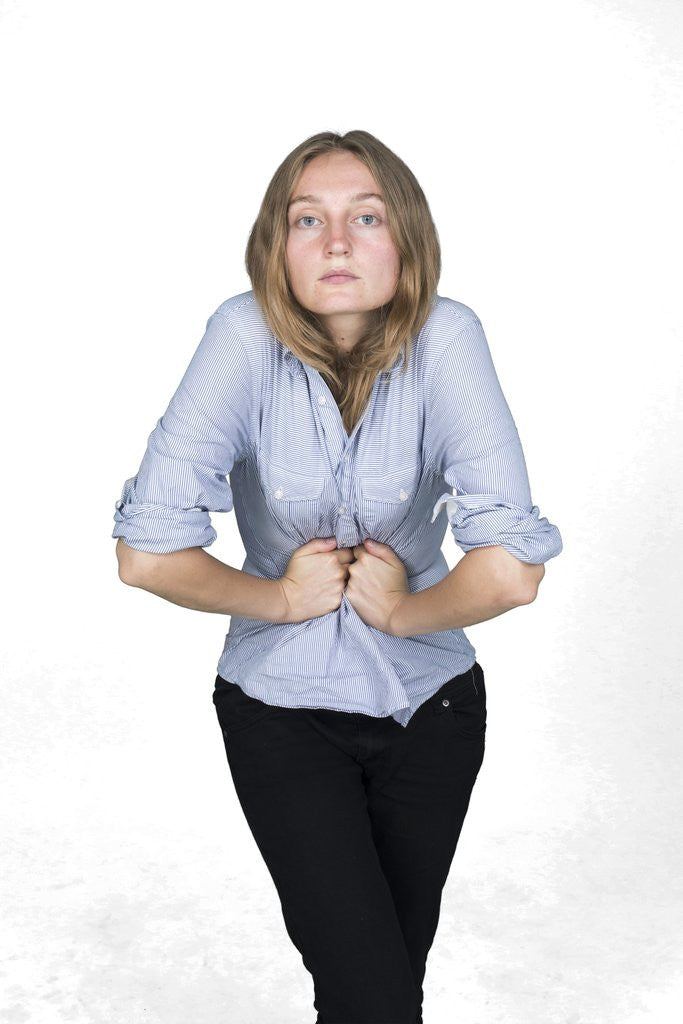 Detail of Woman with hands on stomach by Corbis