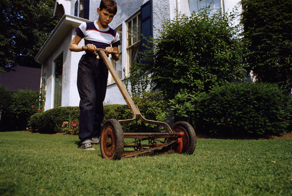 Detail of Boy Mowing Lawn by Corbis