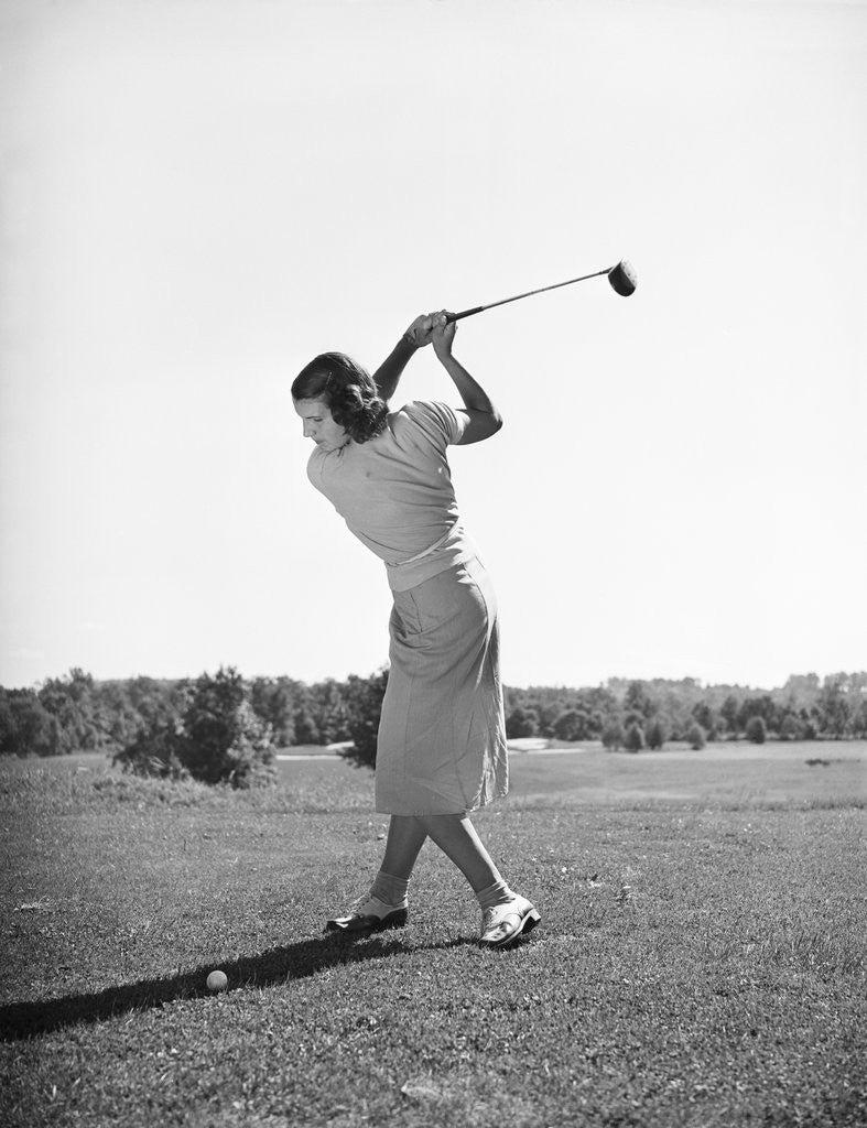 Detail of Woman Swinging Golf Club by Corbis