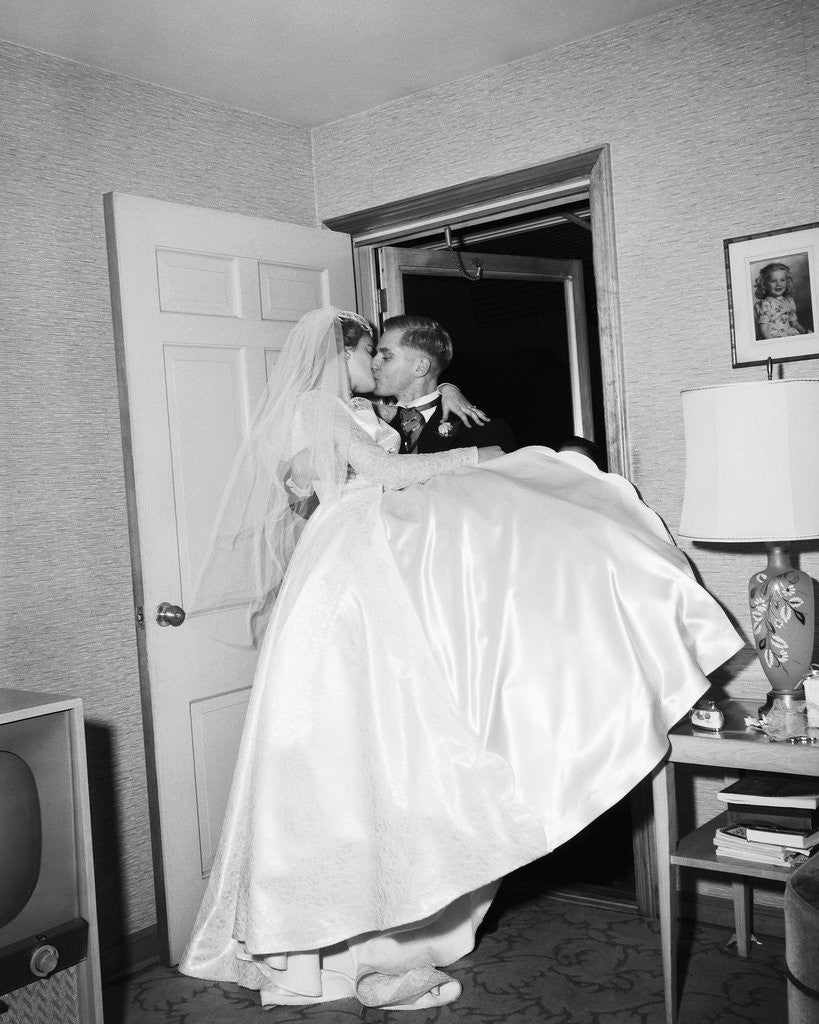 Detail of Groom Carrying Bride over Threshhold by Corbis