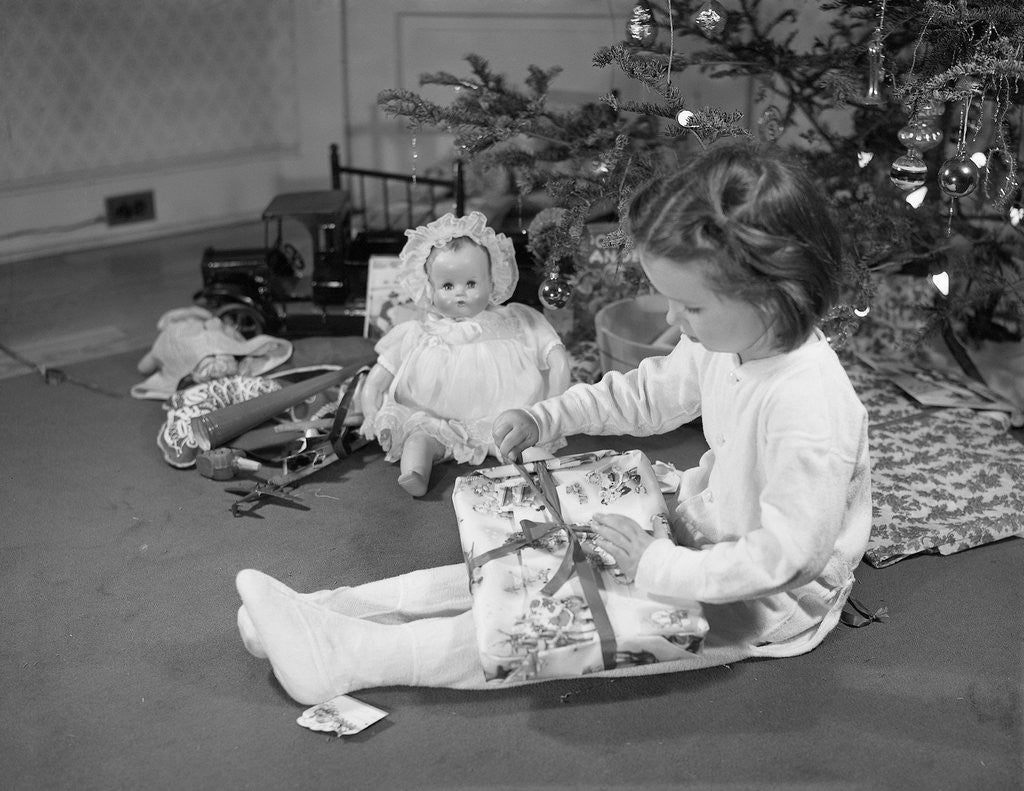 Detail of Girl Unwrapping a Gift by Corbis