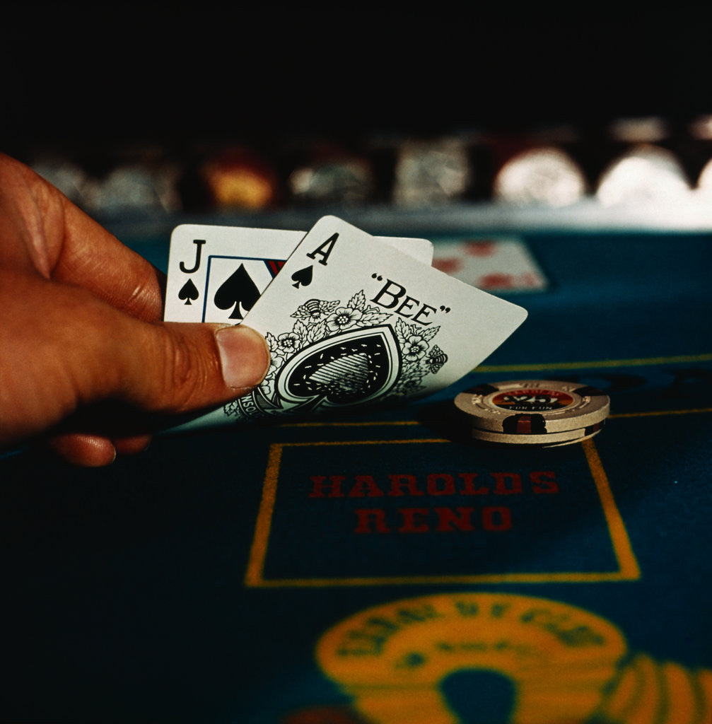 Detail of Hand Holding an Ace and Jack of Spades Cards by Corbis