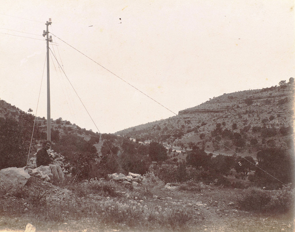 Detail of Traveler on a rock by a telegraph pole in a landscape in Persia by Antoine Sevruguin