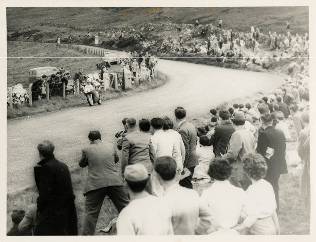 Detail of TT (Tourist Trophy) rider number 1 passes large crowd on the Mountain by T.M. Badger